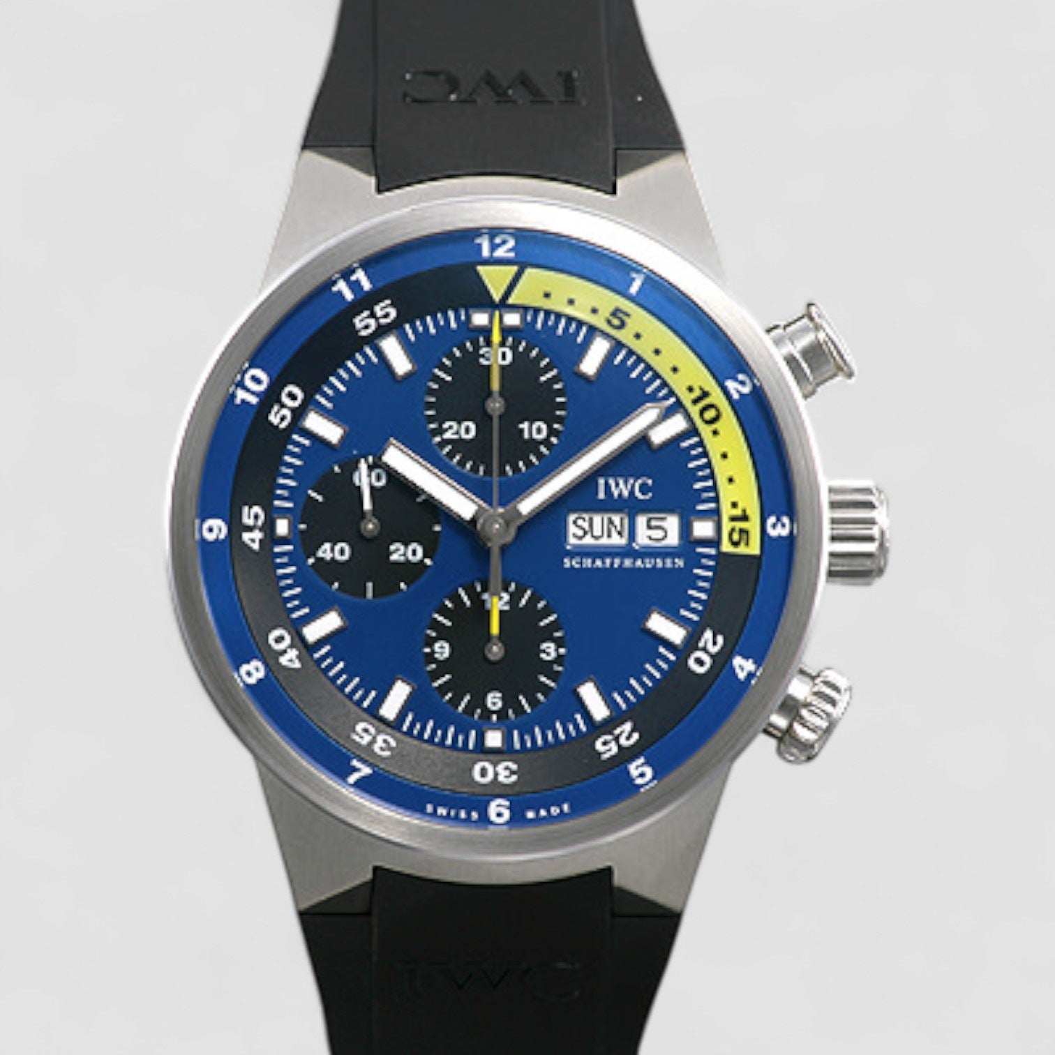 Wristwatch with blue dial and black strap on a light gray background
