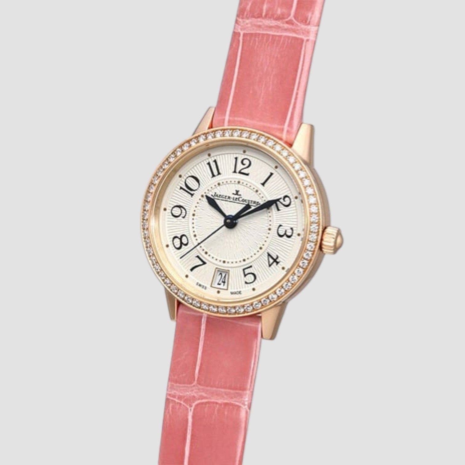 Wristwatch with pink strap and gold case on a light gray background