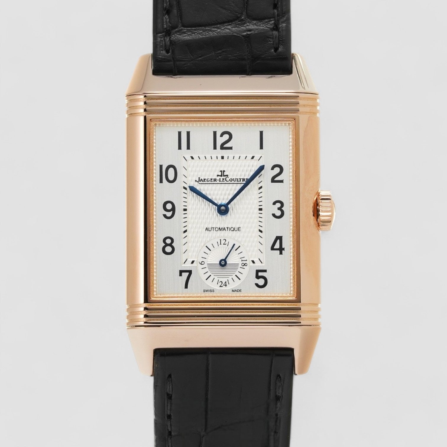 A rose gold Jaeger-LeCoultre Reverso Classic Large Duoface watch with a silver and black dial, displayed against a white background.