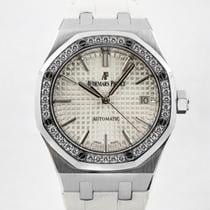 An Audemars Piguet Royal Oak watch with a stainless steel case and a diamond-set bezel, featuring a silver dial and a white leather strap.