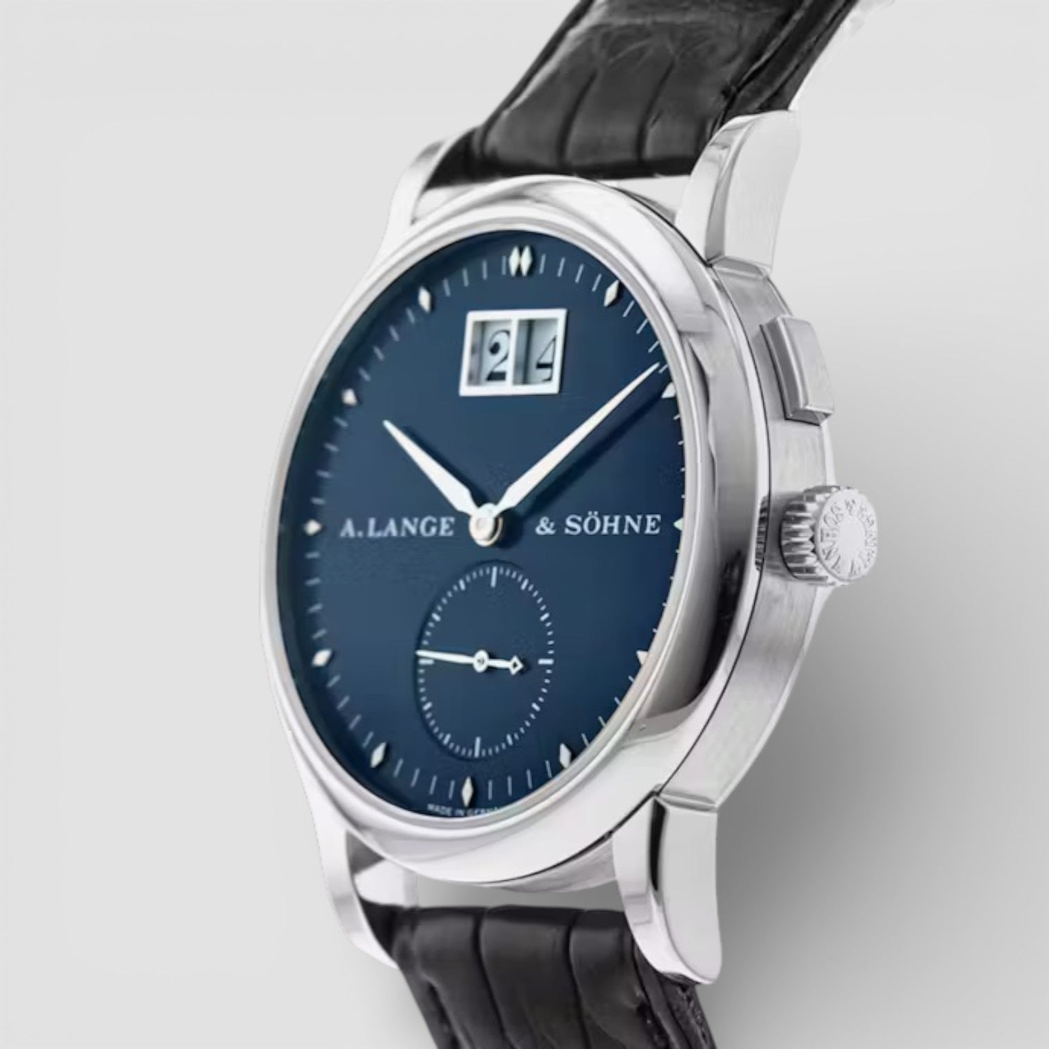 A Lange & Söhne watch with a blue dial and black leather strap on a light gray background