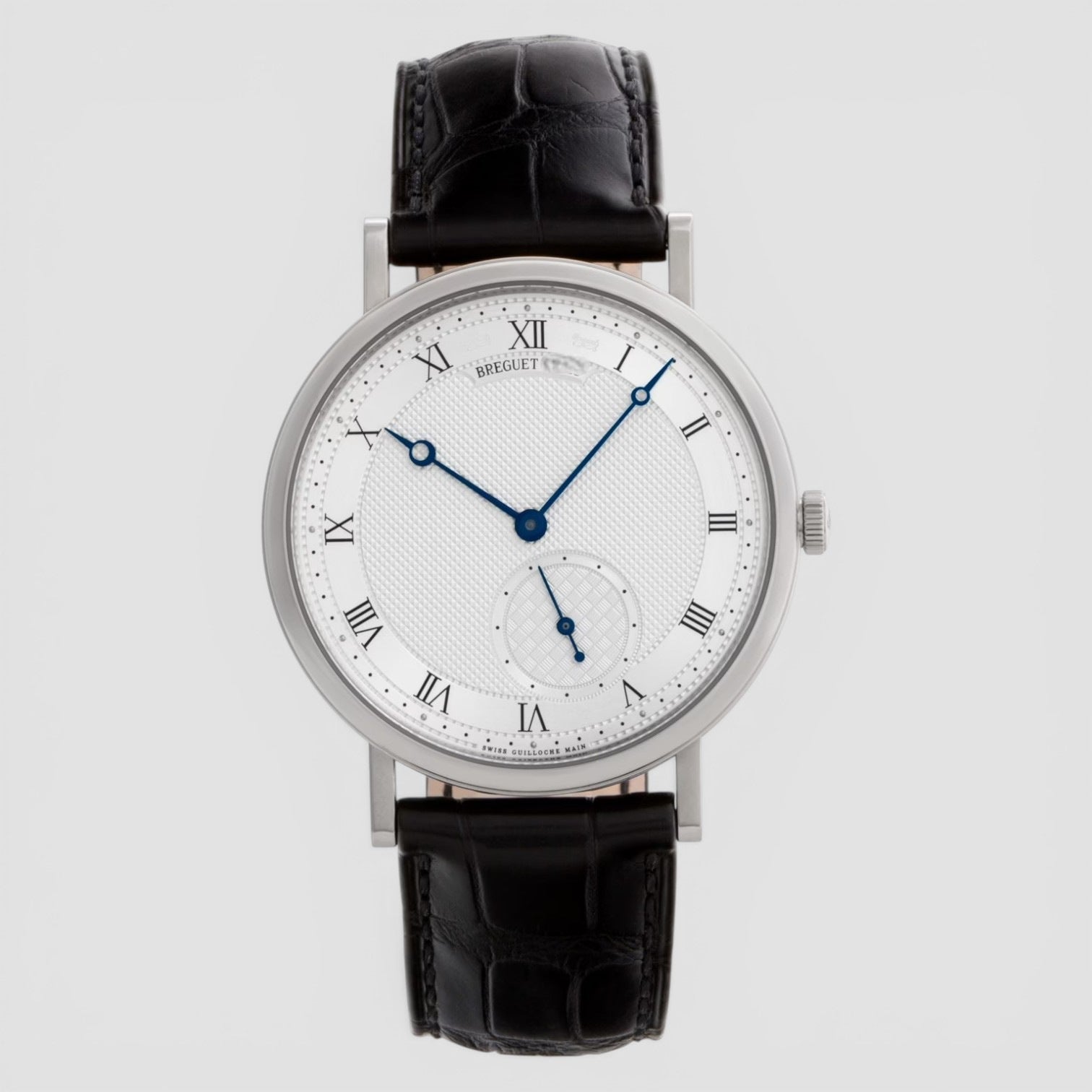Watch with black leather strap and white face on gray background