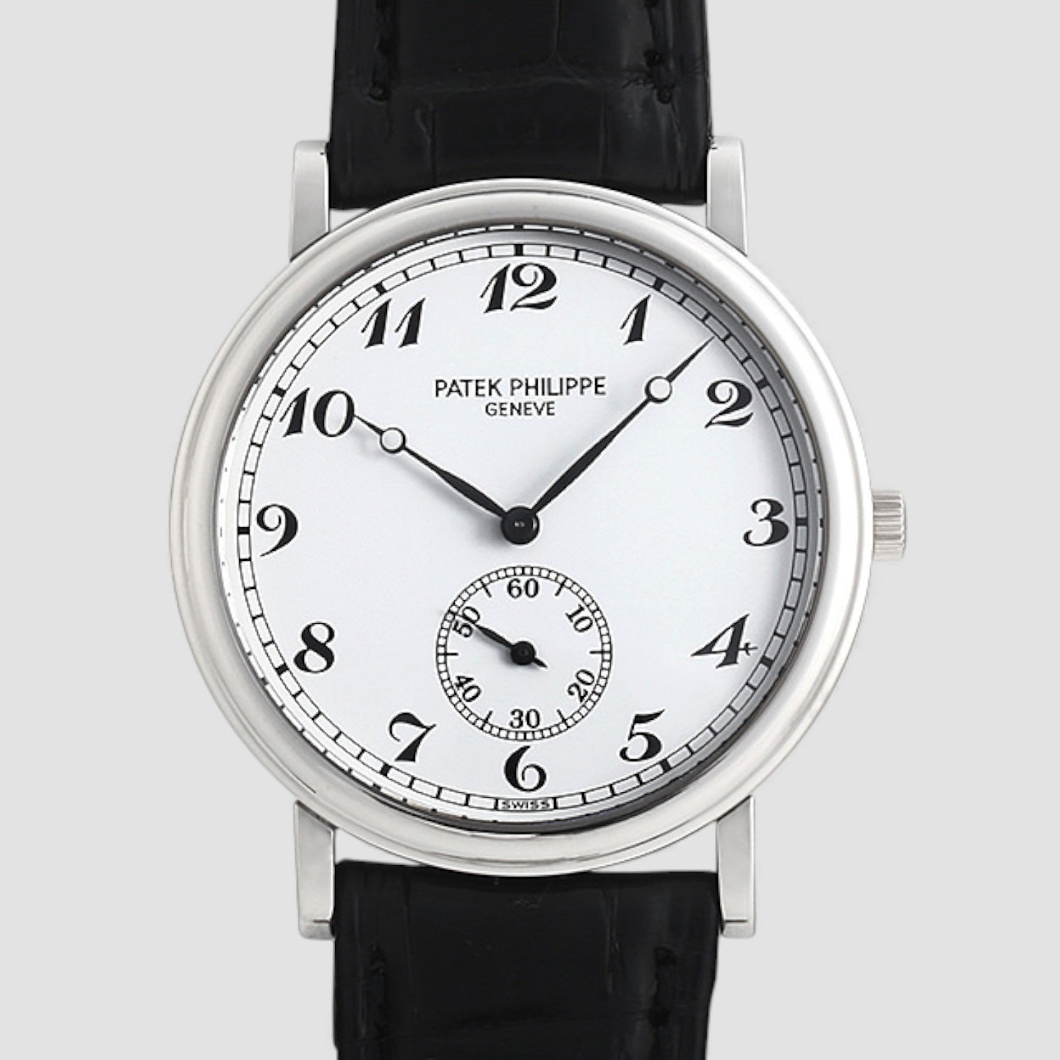 Patek Philippe watch with black leather strap on a light gray background