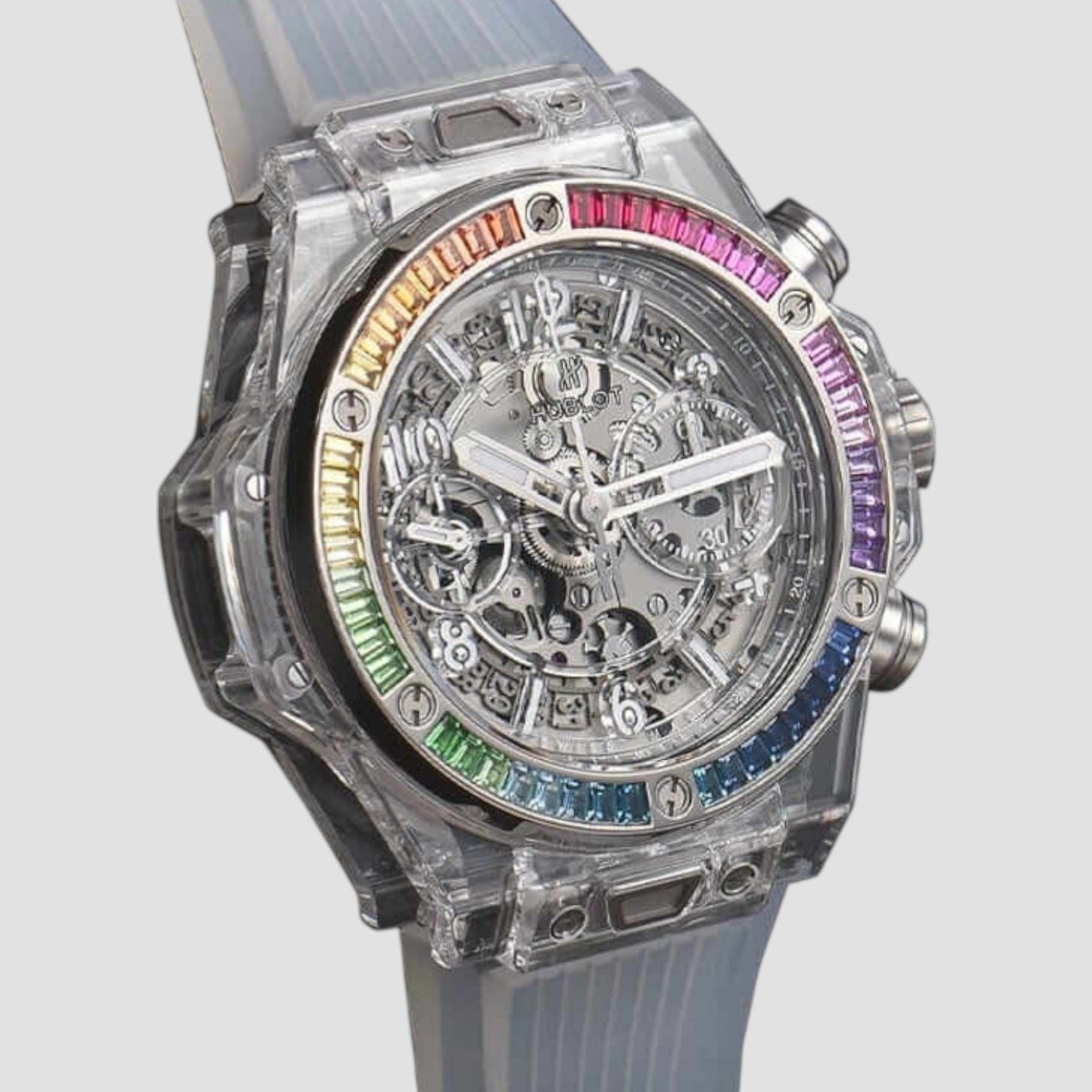 Luxury watch with transparent case and colorful gemstones on a light gray background