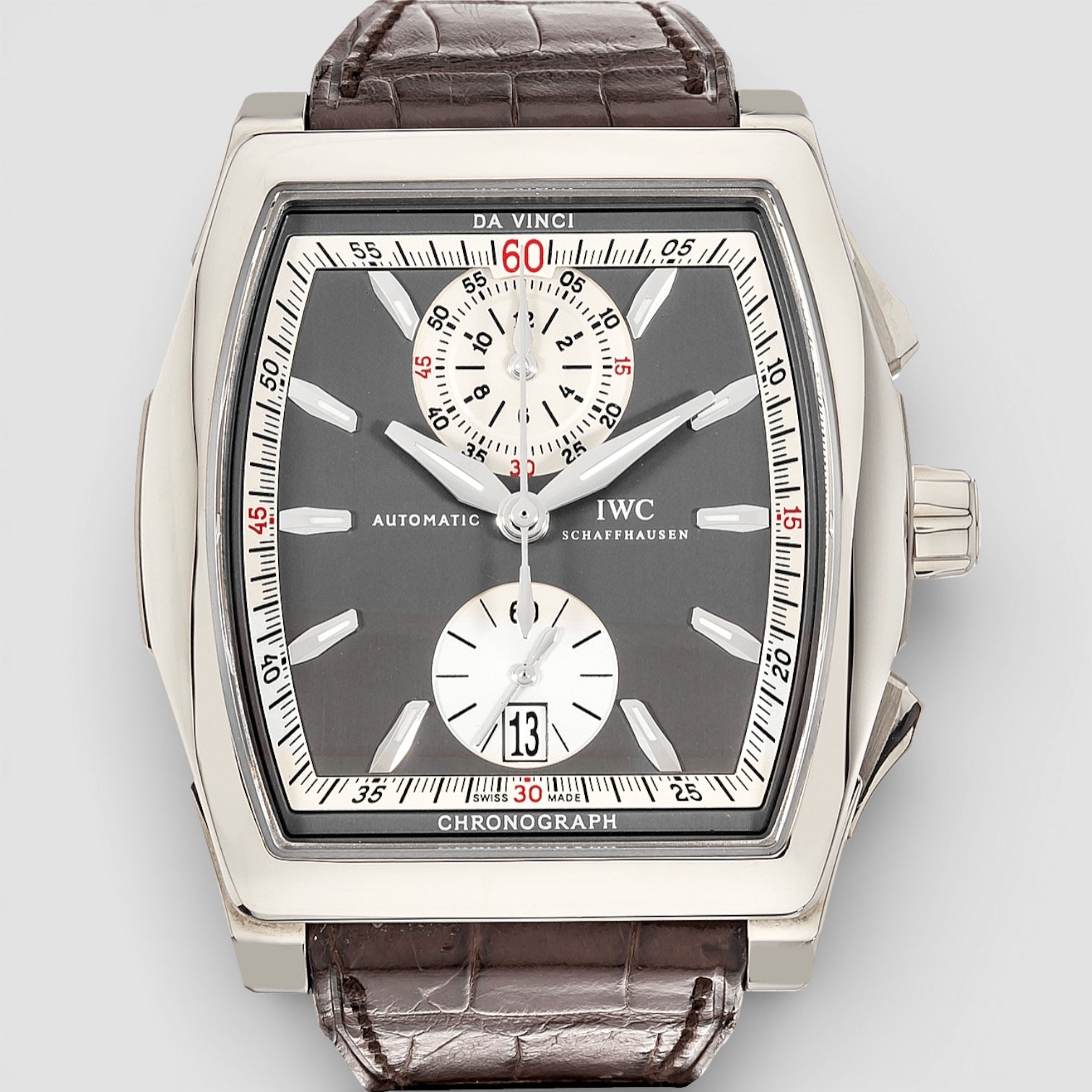 IWC watch with brown leather strap on a light gray background