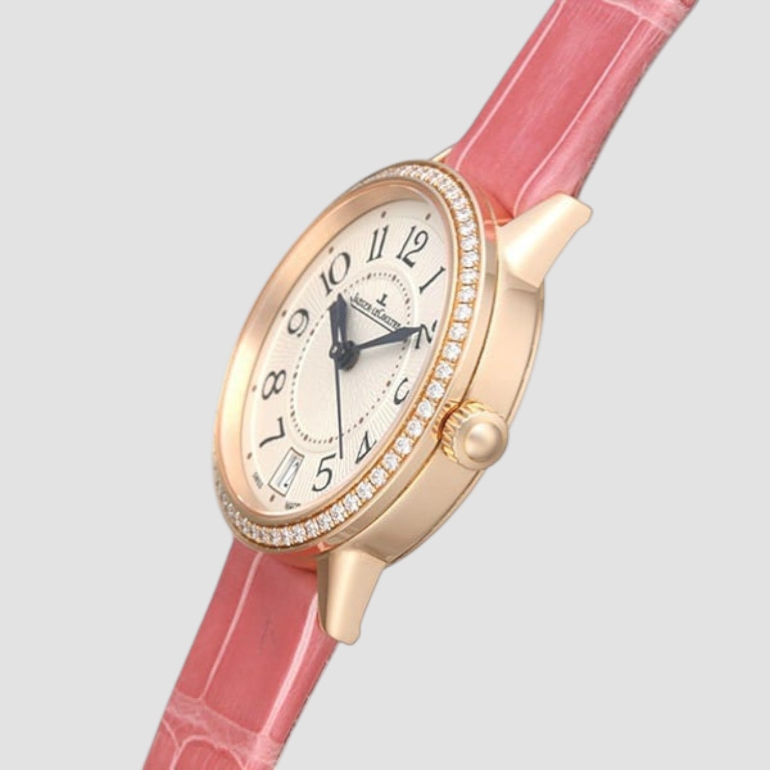 Wristwatch with pink strap and gold case on a light gray background