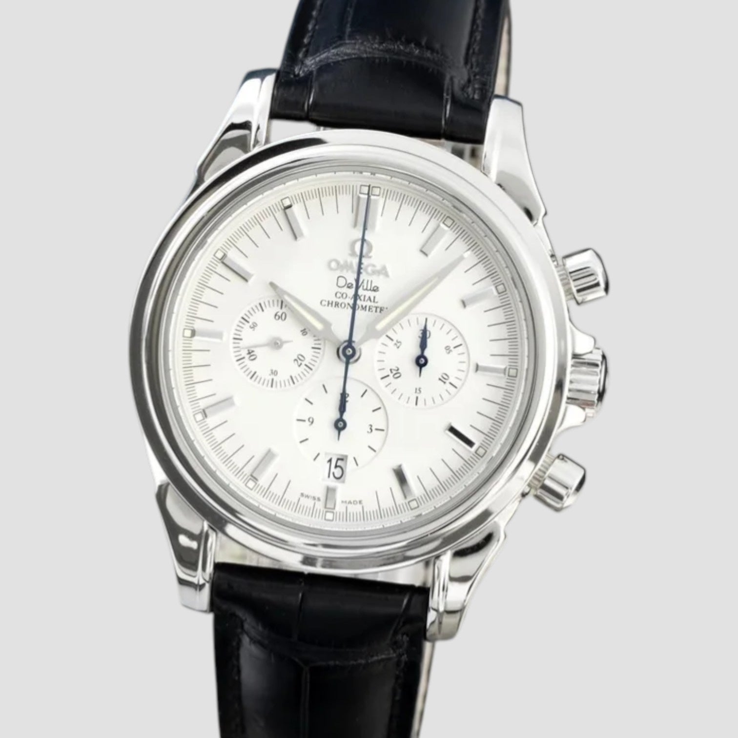 Silver watch with a black leather strap on a light gray background