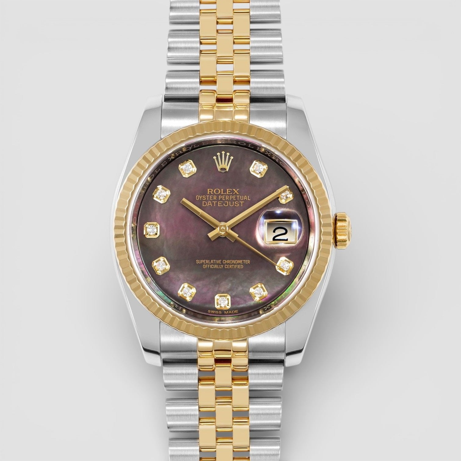Luxury watch with silver and gold band on a light gray background